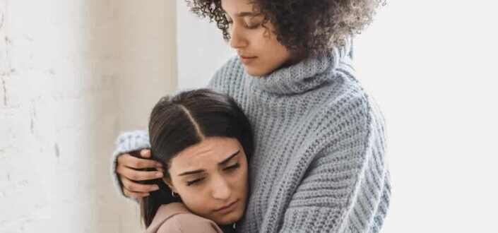 women hugging her friend