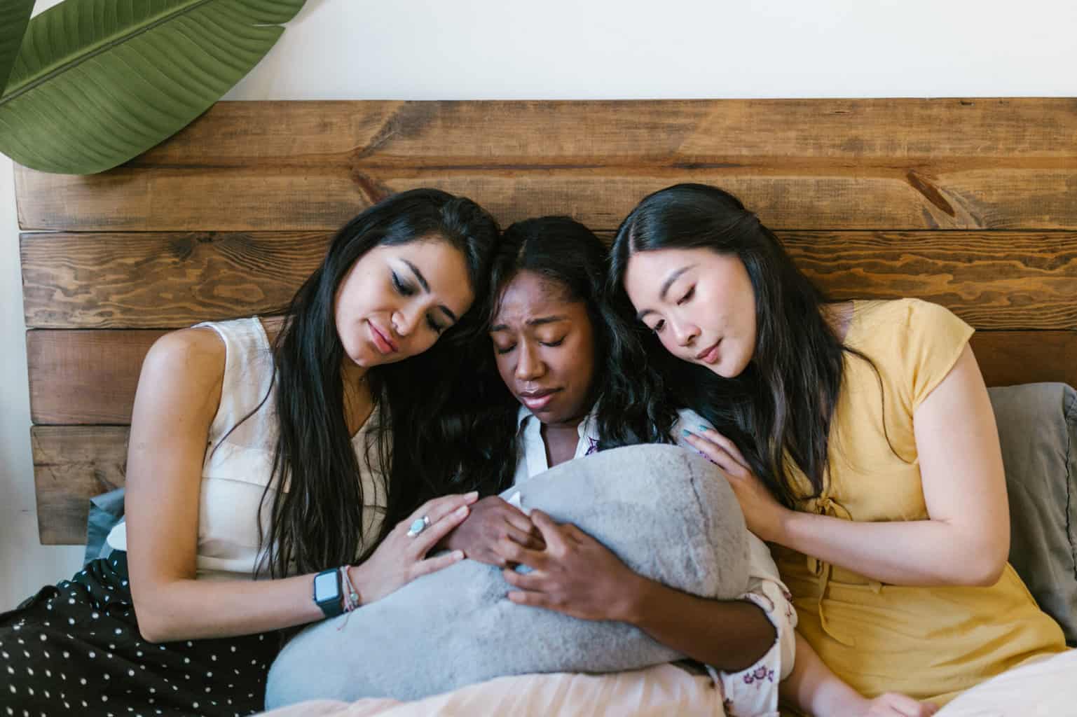 Women comforting a sad woman