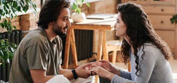 a couple touching hands while talking