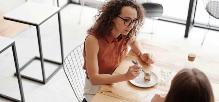 A woman eating dessert while talking