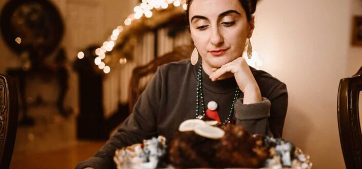 A woman wearing earrings sitting at table
