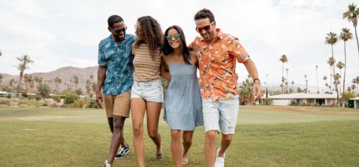 group of friends walking on the grass field