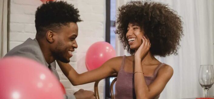 couple laughing while having date at table