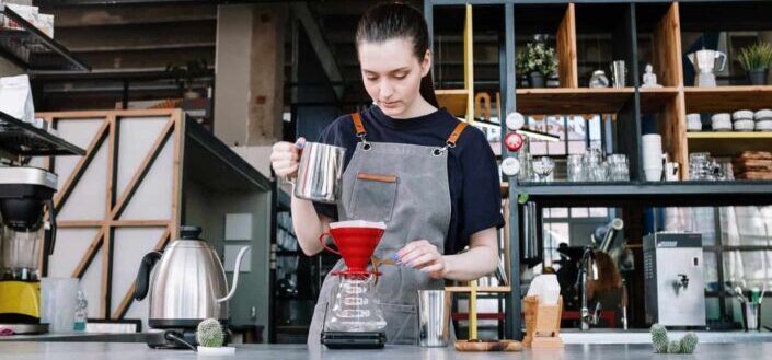 Young lady mixing coffee manually