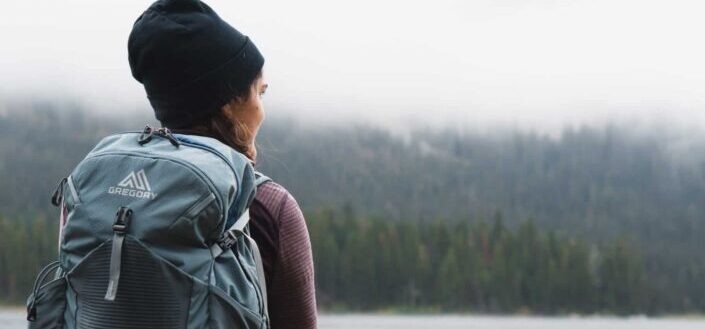 woman carrying gray backpack