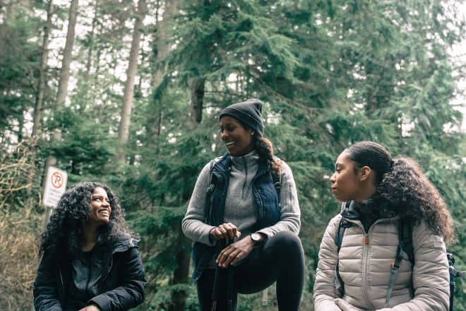Three women hiking at rest while chatting - Fun Hobbies For Women