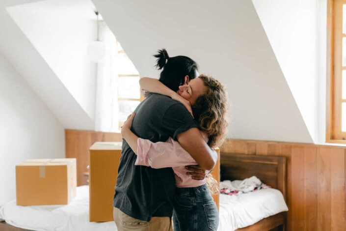 Happy couple hugging after moving in