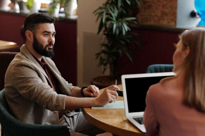 Man and woman talking while working