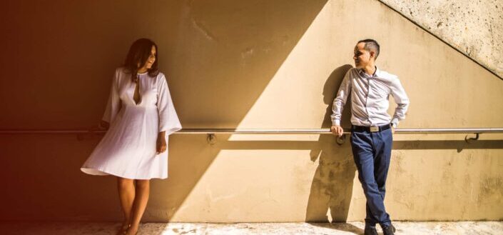Man Leaning on Rail Facing a Woman