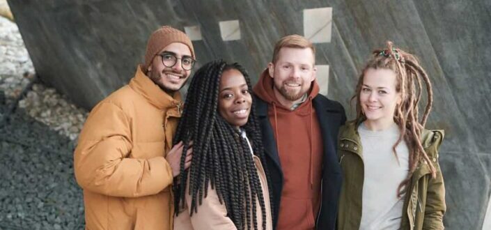 People standing beside concrete wall