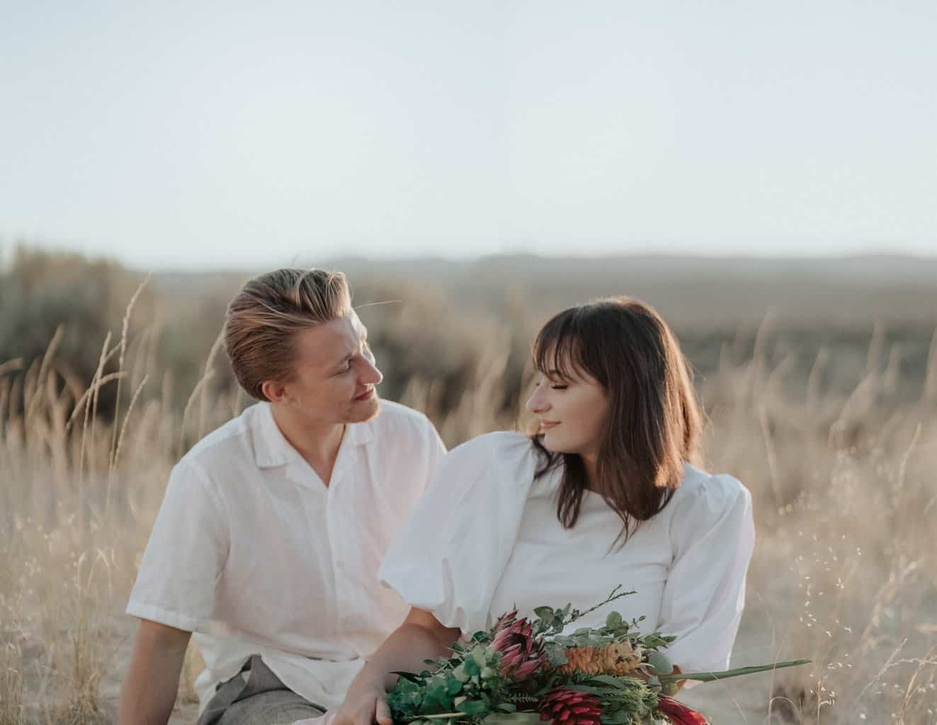 Smiling couple on grassy meadow in nature