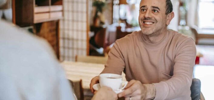 Waiter Serving Coffee to a Man