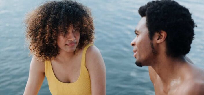 Woman in Yellow Swimsuit Talking to a Man