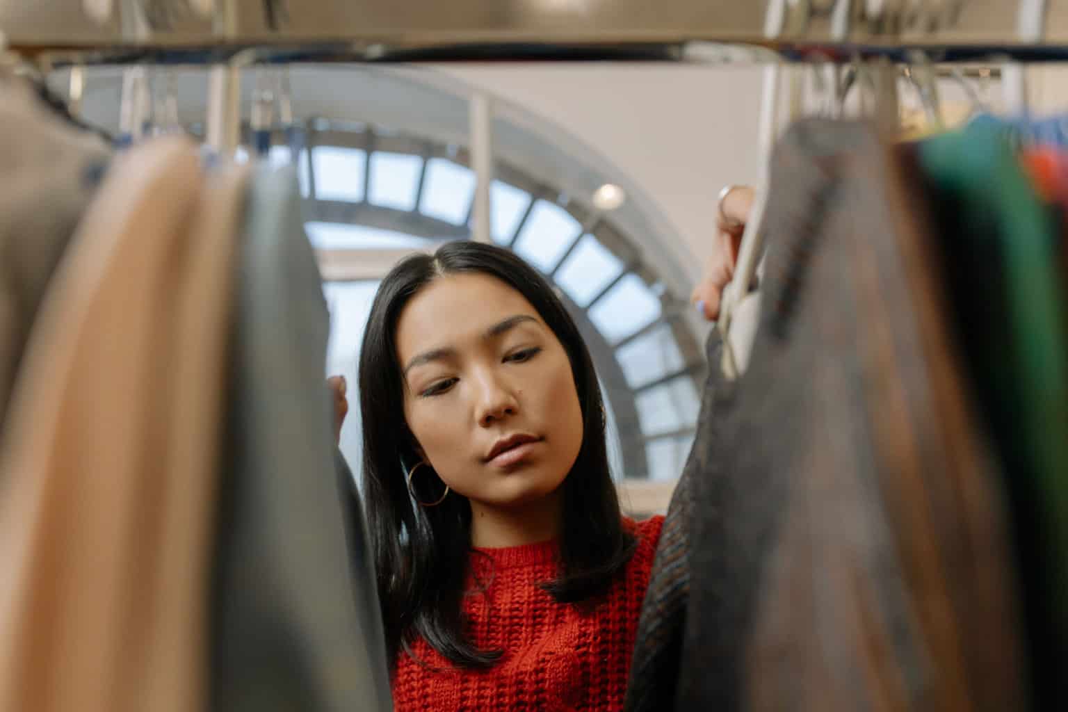 Woman looking at the hanging clothes