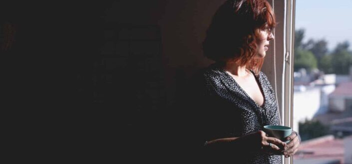 Woman Looking Outside the Window