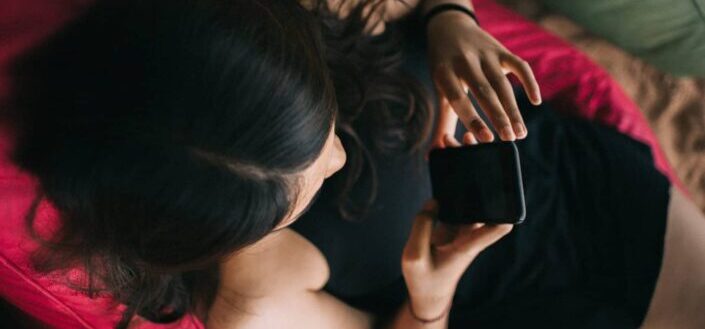 Woman Sitting on Chair While Using Phone