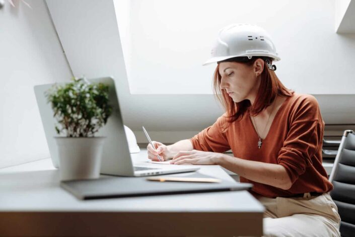 Woman wearing white hard hat