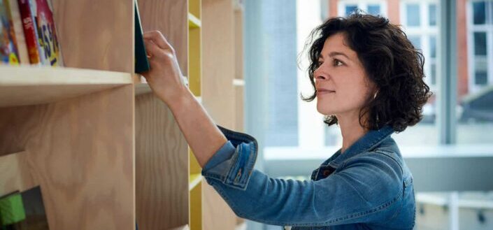 woman choosing books from shelf