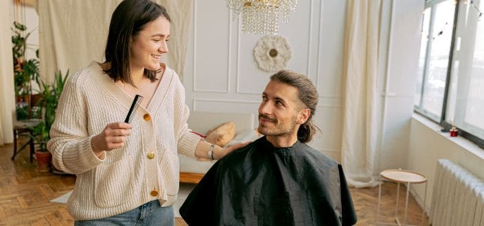 woman with a comb standing beside a man