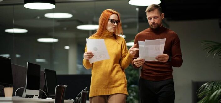A man and a woman looking at documents