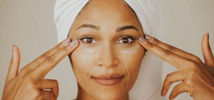 A woman applying a facial cream