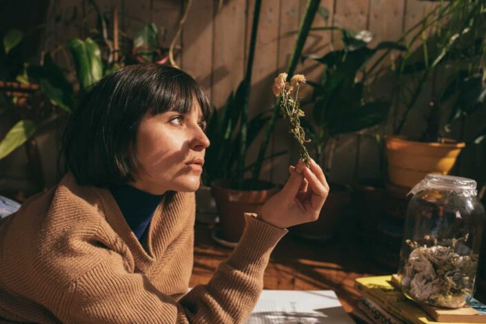  woman looking at dried flowers