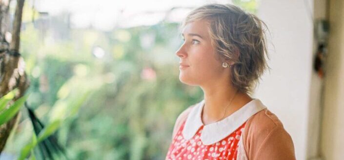 A woman in orange polka dot top