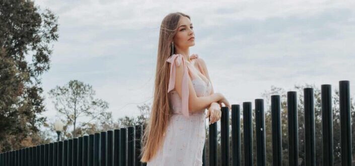 Blonde long haired woman in delicate dress