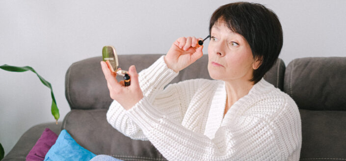 woman in white cardigan sitting on couch