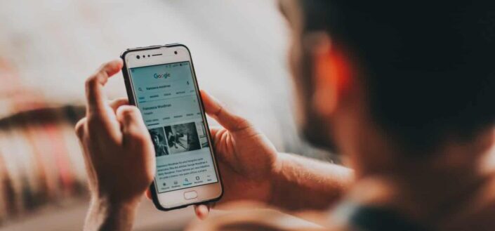Man surfing internet on smartphone at home