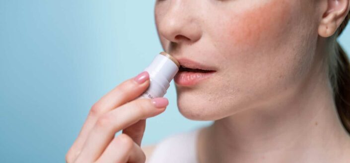 woman using a lip balm