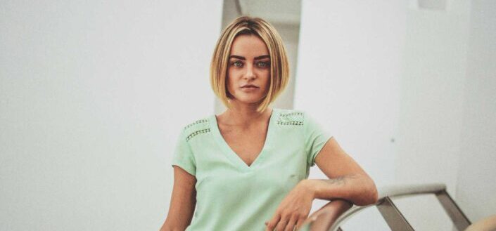 Blonde woman wearing a light green shirt