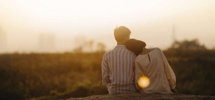 Man and woman near grass field