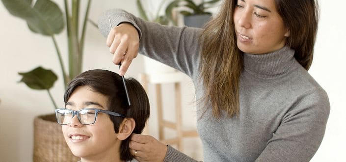 A mother combing her son