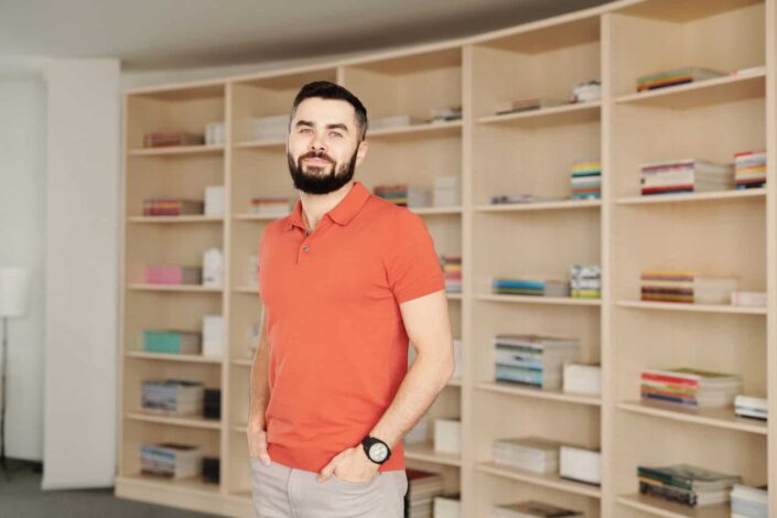 man wearing an orange polo shirt