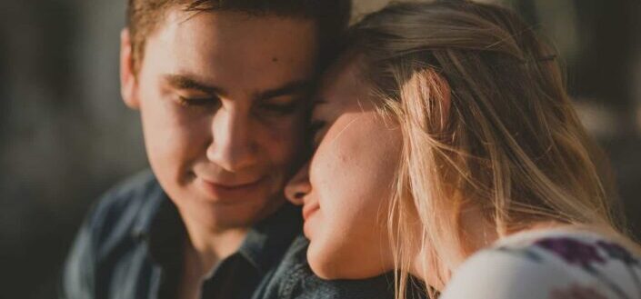 woman leaning on her boyfriend