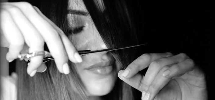 woman trimming her fringe