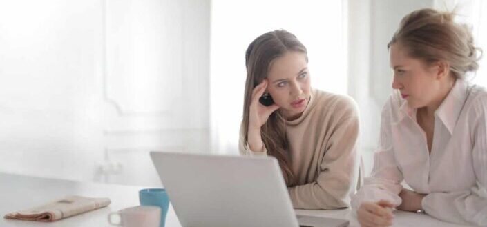 women discussing project in home office