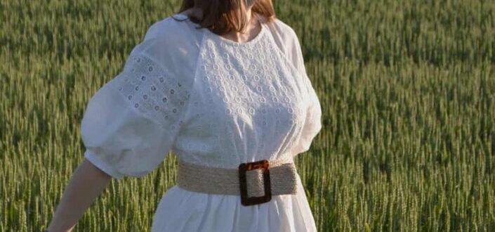 Woman in a white dress in grass field