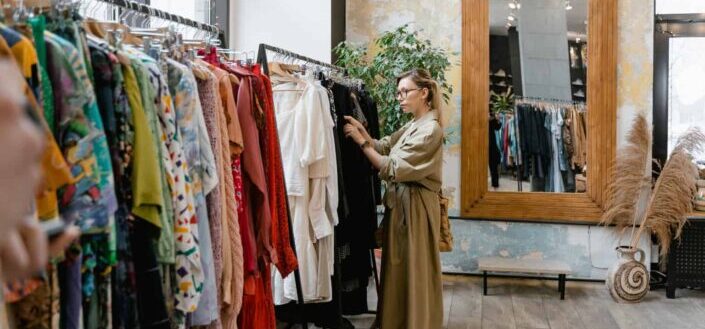 Woman picking out clothes from a rack