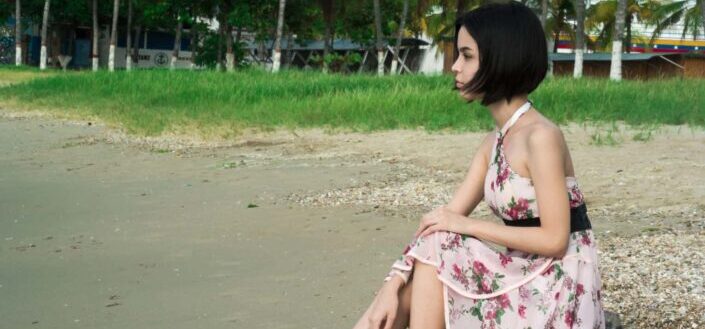 Woman in pink floral halter dress