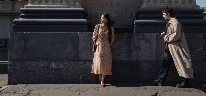 Woman standing in front of colonnade