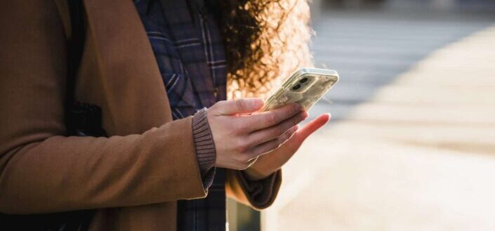 Woman sending messages on smartphone