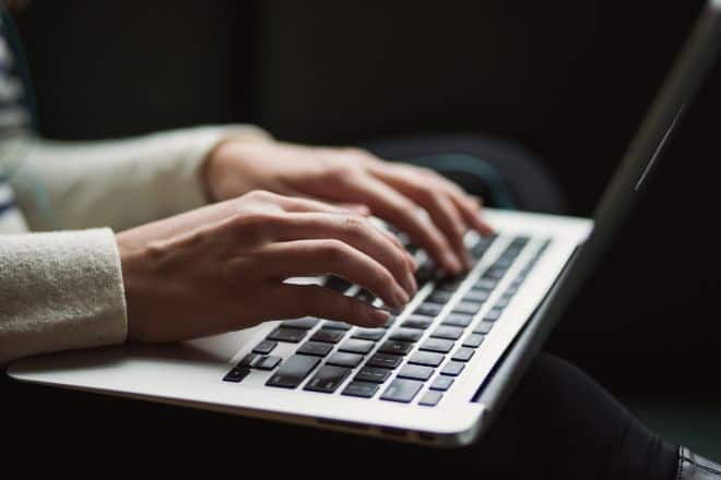 person using laptop - Questions To Ask A Romance Scammer