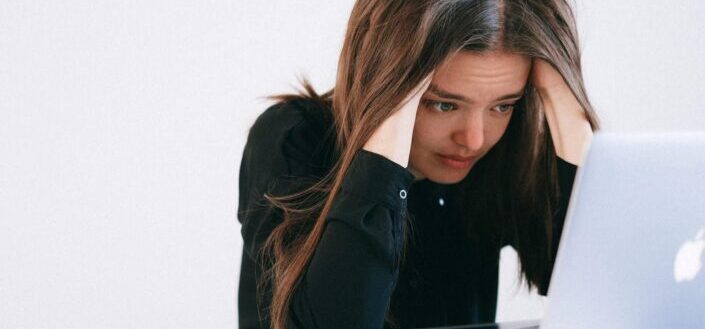 Stressed woman looking at a laptop