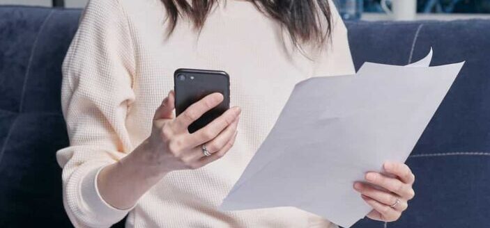 Woman holding black smartphone