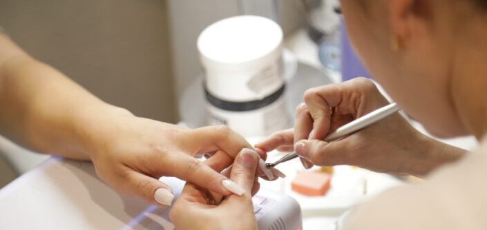 Woman getting her nails done at a salon