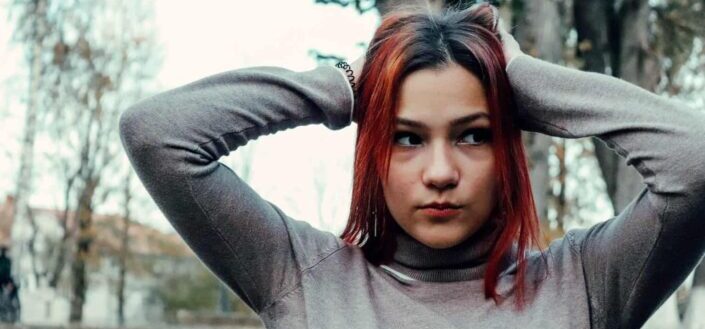 Autumn photo session of a red-haired girl in bright colors